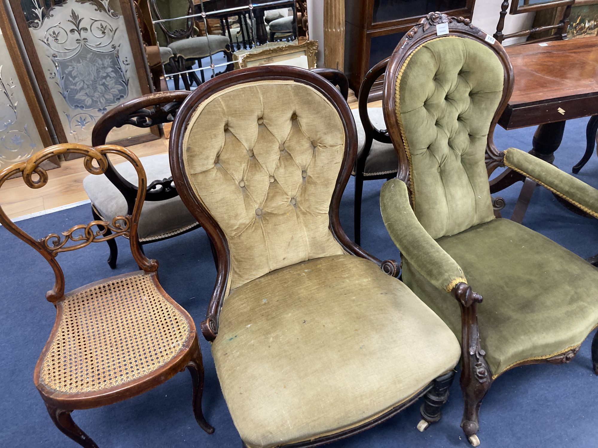 A Victorian mahogany open armchair, a Victorian nursing chair, five balloon back dining chairs and a caned chair